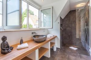 a bathroom with a sink and a large window at Fährhaus Sellin Haus am See in Ostseebad Sellin