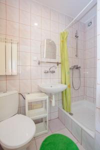 a bathroom with a toilet and a sink and a shower at Pokoje Gościnne Pod Gubałówką in Zakopane