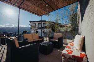 a balcony with furniture and a view of the mountains at Casa dos Avós- Douro in Peso da Régua