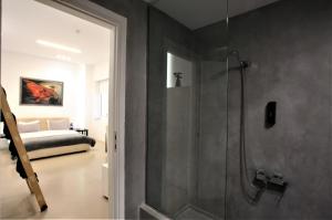 a bathroom with a shower with a glass door at GK Athens in Athens
