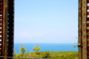 a view of the ocean from a train window at Casale del Mare in Castiglioncello