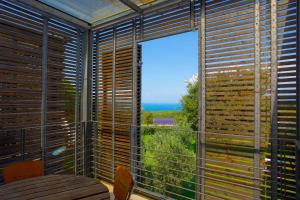 a room with a large window with a view of the ocean at Casale del Mare in Castiglioncello