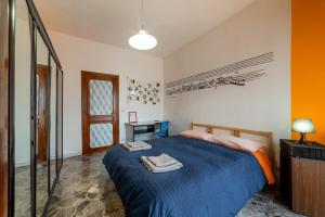 a bedroom with a blue bed and a mirror at House of Arts in Bari
