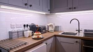 a kitchen with a cake sitting on a counter at River Mist in Ironbridge