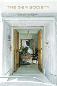 a room with a door leading to a bathroom at The Gem Society Hotel in Athens