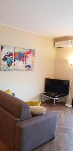 sala de estar con sofá y TV de pantalla plana en CIGNI HOUSE - da Anna&Ale, en Basiglio
