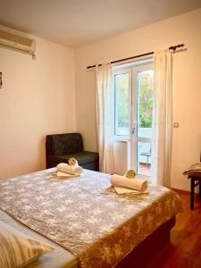 a bedroom with a bed with two books on it at Apartments Miljas in Cavtat