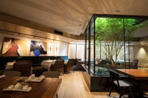 a restaurant with tables and chairs and a large window at Zenit Convento San Martin in Donostia-San Sebastián