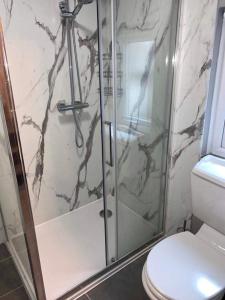 Un baño con ducha de cristal con inodoro. en The Nook, en Embleton 7 fotos más