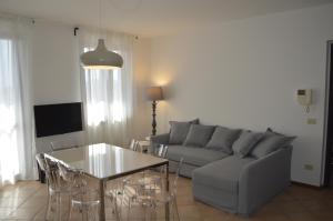 V12 Apartments - Trecate في Trecate: غرفة معيشة مع أريكة وطاولة