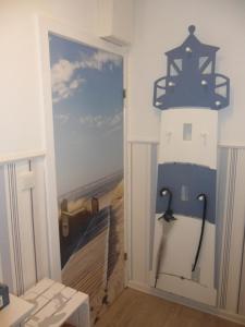 a room with a lighthouse mural on the wall at Seemannskiste in Grömitz +15 photos