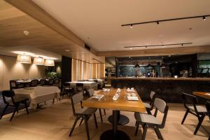 a restaurant with tables and chairs and a bar at Zenit Convento San Martin in Donostia-San Sebastián