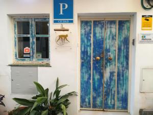 a blue door and a window on a building at Hostal The Monkey Room in Marbella