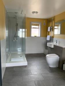 a bathroom with a shower and a toilet and a sink at The Red Lion Inn in Spilsby