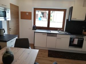 a kitchen with a sink and a table in a room at Appartements Spitaler in Ried im Zillertal