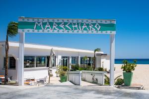 a building on the beach with a sign on it at Il Nocchiero City Hotel in Soverato Marina