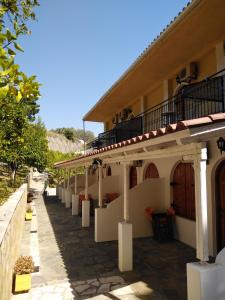 a row of white buildings with balconies on them at Ηotel Della in Parga