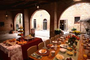 a long table with food on it in a room at villa San Fabiano with heated pool in Monteroni dʼArbia