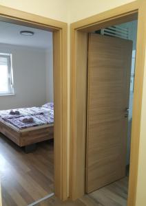 a sliding door in a bedroom with a bed at Eko kmetija Gerbec in Grahovo