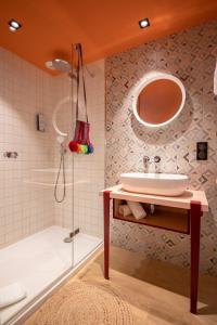 a bathroom with a sink and a shower at PAUL & PIA - Welcome Home Hotel in Colmar