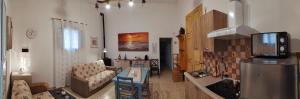 a living room with a couch and a kitchen with a refrigerator at Dedo B&B in Terlizzi +68 photos