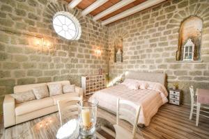a bedroom with a bed and a couch and a table at Tenuta C'est la Vie in Ischia