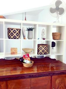 a shelf with bowls and baskets on top of a wooden table at Villa with fantastic view in Perea