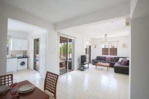 a living room with a couch and a table at Mandali Villa in Protaras