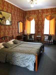 a bedroom with a large bed with red wallpaper at Guest House na Velikoy in Pskov