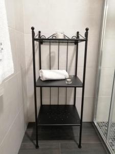 a black shelf in a bathroom with a towel at Raiz Alentejana in Reguengos de Monsaraz +68 photos