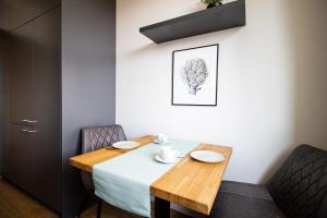 a dining room with a table and two chairs at Patio Praga Metro Apartment in Warsaw