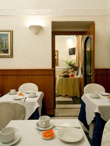a dining room table with two chairs and a table cloth at Hotel Sonya in Rome