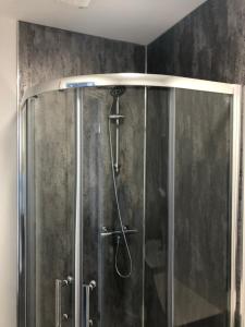 a shower with a glass enclosure in a bathroom at The Holystone Bar & Restaurant in Forest Hall