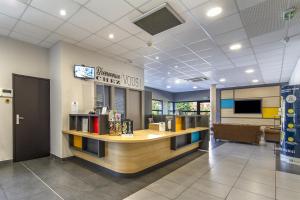 a lobby of a library with a reception desk at B&B HOTEL Perpignan Saleilles in Perpignan