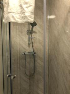 a shower stall with a glass shower door at The Holystone Bar & Restaurant in Forest Hall