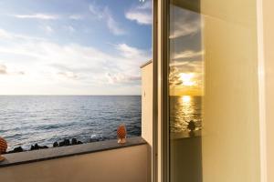a view of the ocean from a window at Taliammari in Cefalù