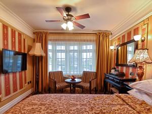 a bedroom with a bed and a desk and a window at Riverside Inn in Ely