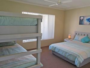 a bedroom with two beds and a window at 15 'Kanangra', 39 Soldiers Point Road - fantastic unit right on the water in Soldiers Point