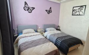 מיטה או מיטות בחדר ב-GrayAppart Kénitra