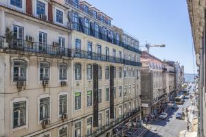 a building with balconies on the side of a street at Silver Side River in Lisbon