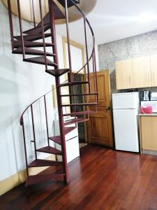 a spiral staircase in a room with a kitchen at 4-As center apartments in Guimarães