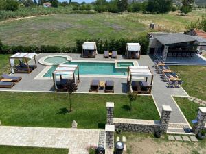 an aerial view of a swimming pool with lounge chairs at A Ponte Studios & Apartments in Sykia Chalkidikis