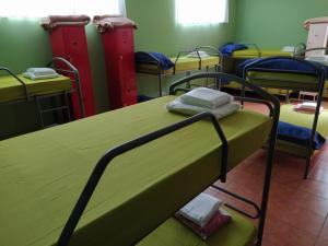 
a room with a bed and a desk with a computer on it at Albergue O Bordón in Cee
