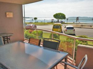 a balcony with a table and chairs and a view of the ocean at Florentine 4 spectacular views and air conditioning in Nelson Bay