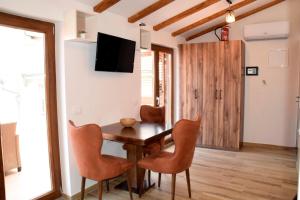 a dining room with a wooden table and chairs at Apartments ELA in Piran