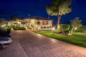 a house with a car parked in the driveway at night at Fragos Garden Studios in Kyllini