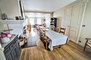 a kitchen and dining room with a table and chairs at LE JABLOIRE in Florent-en-Argonne