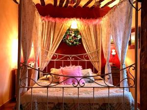 a bedroom with a bed with a canopy at Rural house the Fifth of Malu, Romantic hotel in Cuenca, romantic getaways in Valeria +10 photos