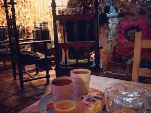 a table with a plate of food and drinks on it at Casa rural la Quinta de Malu Romantic hotel in Cuenca Romantic getaways in Valeria +5 photos