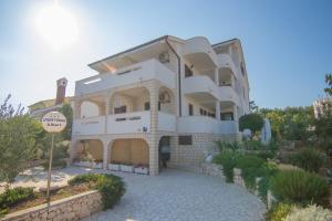 a large white building with a sign in front of it at Albert Apartaments Krk in Krk